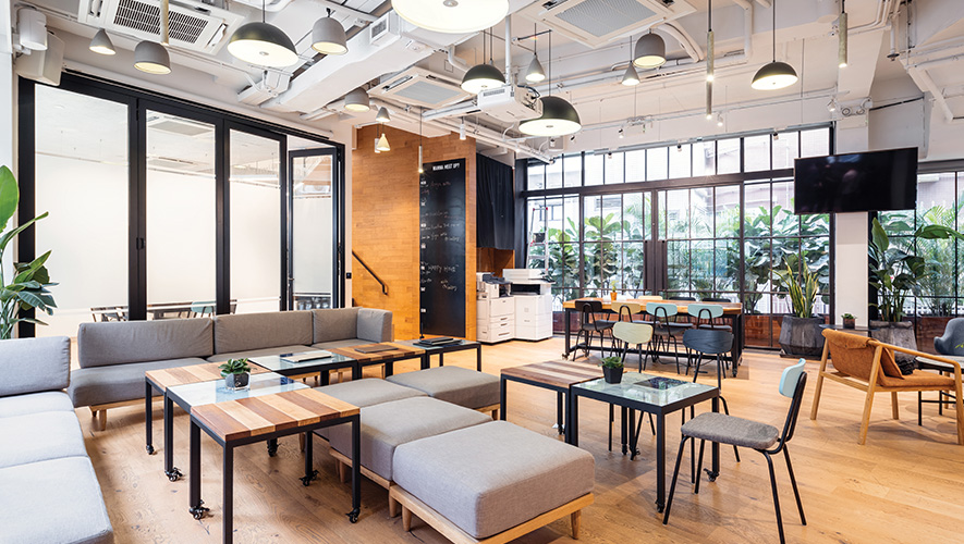 Modern break room at an office building, couches with many light fixtures.