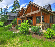 A house with shrubs and green grass