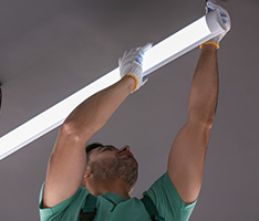 Man installing lighting at a business